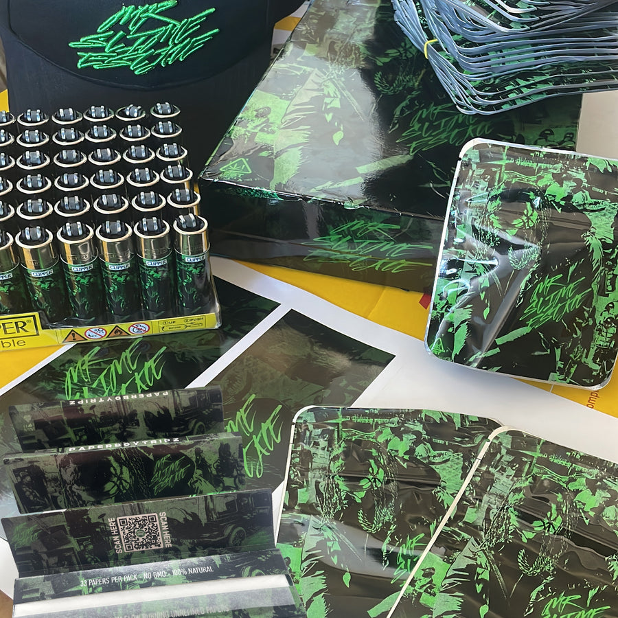 Collection of custom merchandise including boxes, packaging, and a hat with a brand logo. Paperboytripz album launch merch design & print by cloud n9ne.
